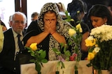 A woman mourns at the service