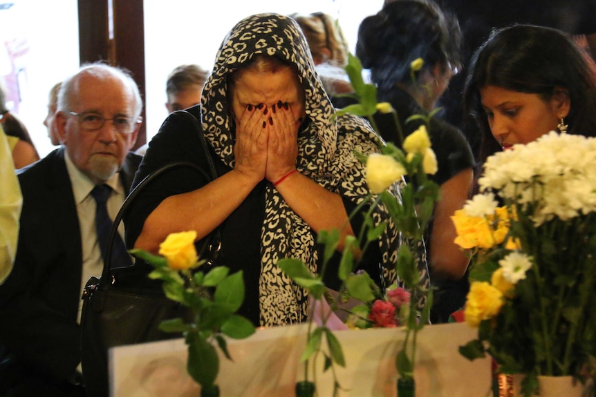 A woman mourns at the service