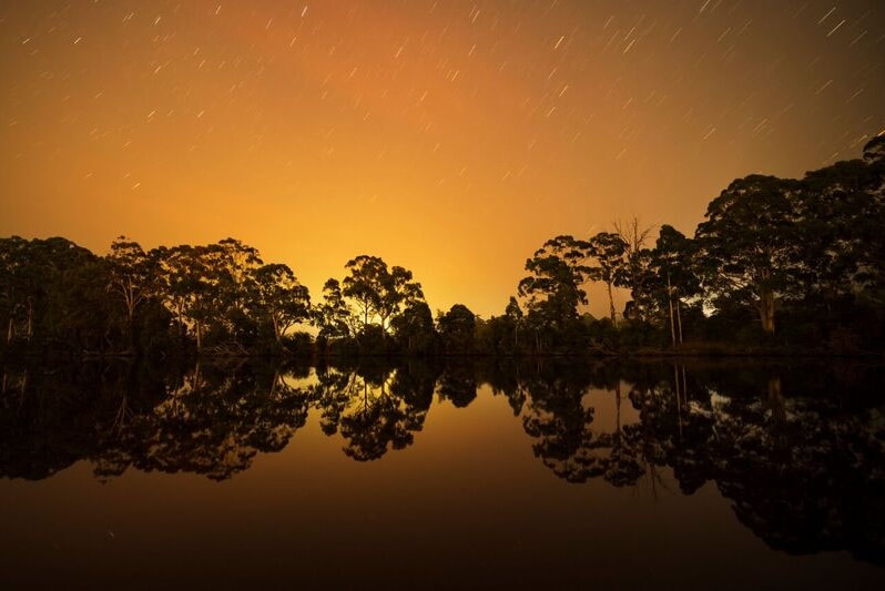 Bushfire glow above Glen Huon reflected in the Huon River at Ranelagh.