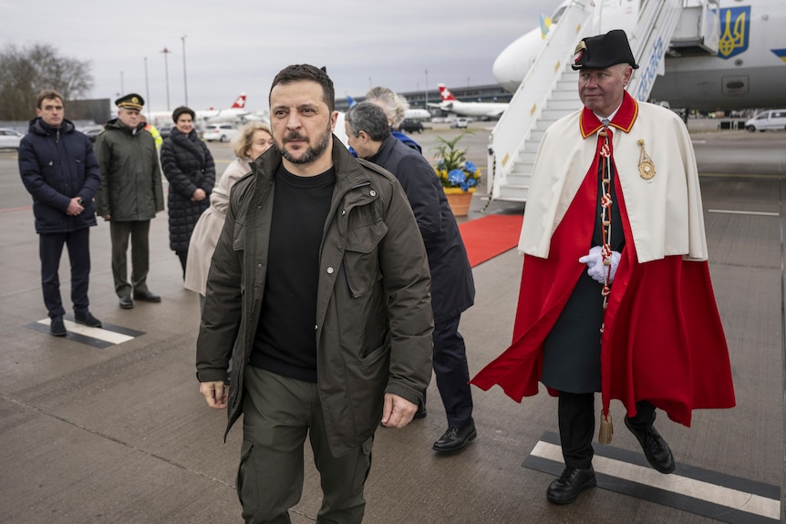Volodymyr Zelenskyy walks away from an airplane