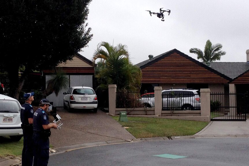 Police deployed a drone to examine the burnt-out house at Westlake in Brisbane's west, which remained too hot to enter on Tuesday morning