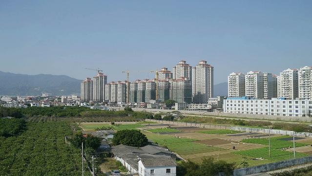 A Chinese city skyline with buildings under construction