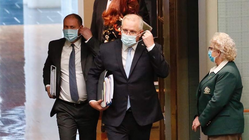 Scott Morrison and Josh Frydenberg enter the House of Representatives wearing face masks.