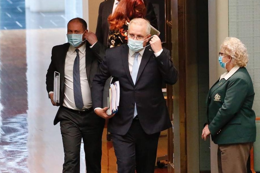 Scott Morrison and Josh Frydenberg enter the House of Representatives wearing face masks.