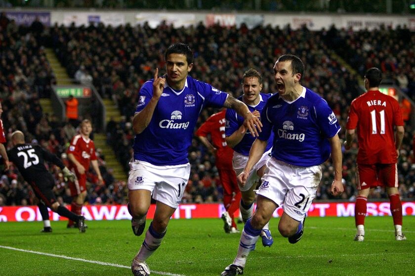 Everton player Tim Cahill, left, celebrates scoring a late equaliser