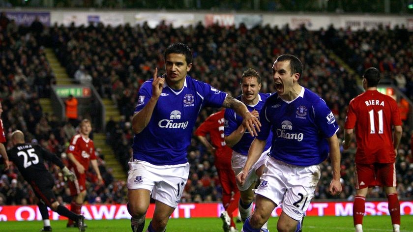 Everton player Tim Cahill, left, celebrates scoring a late equaliser