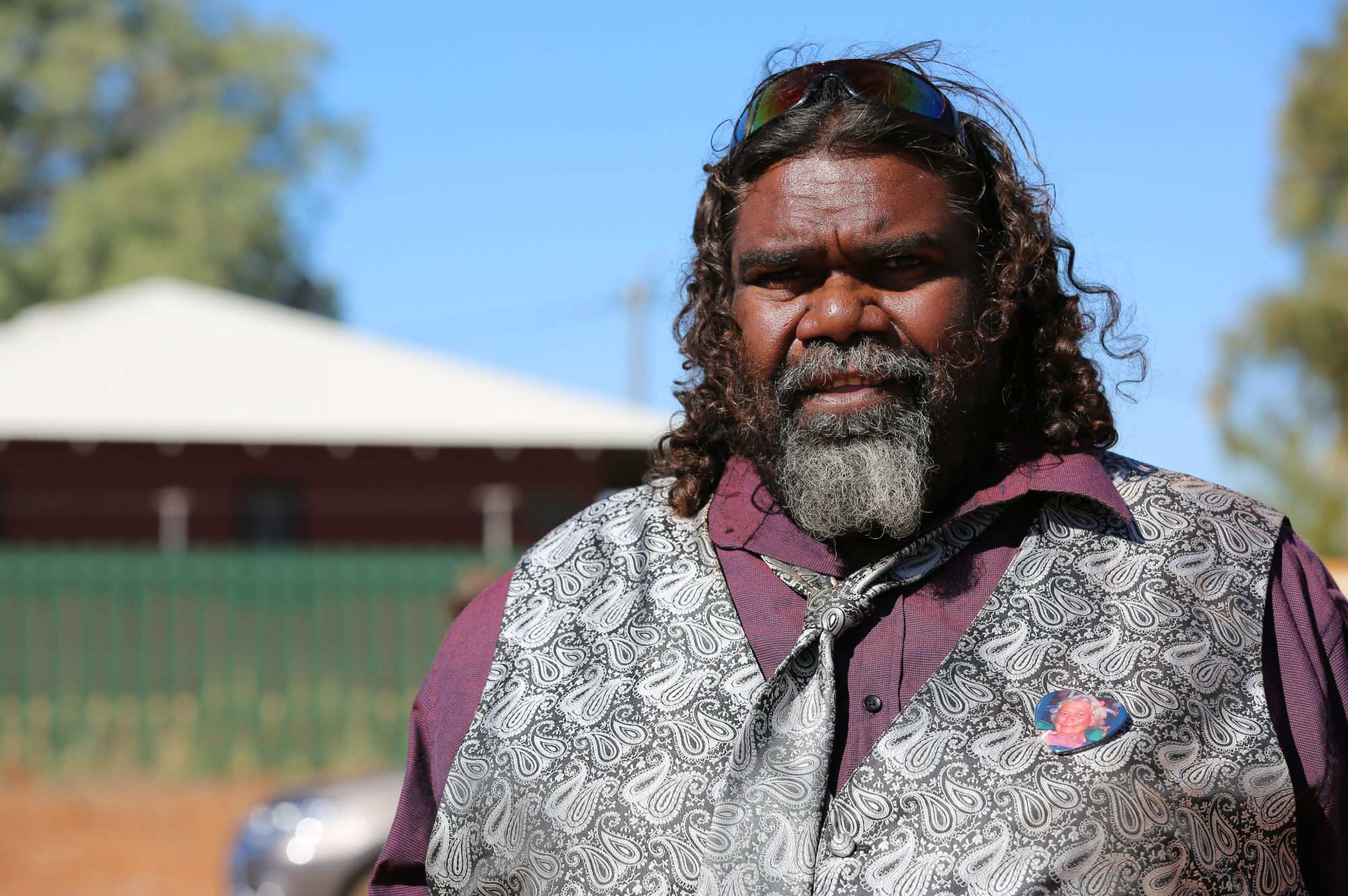 Daisy Kadibil's grandson Darryl Jone stands looking at the camera.