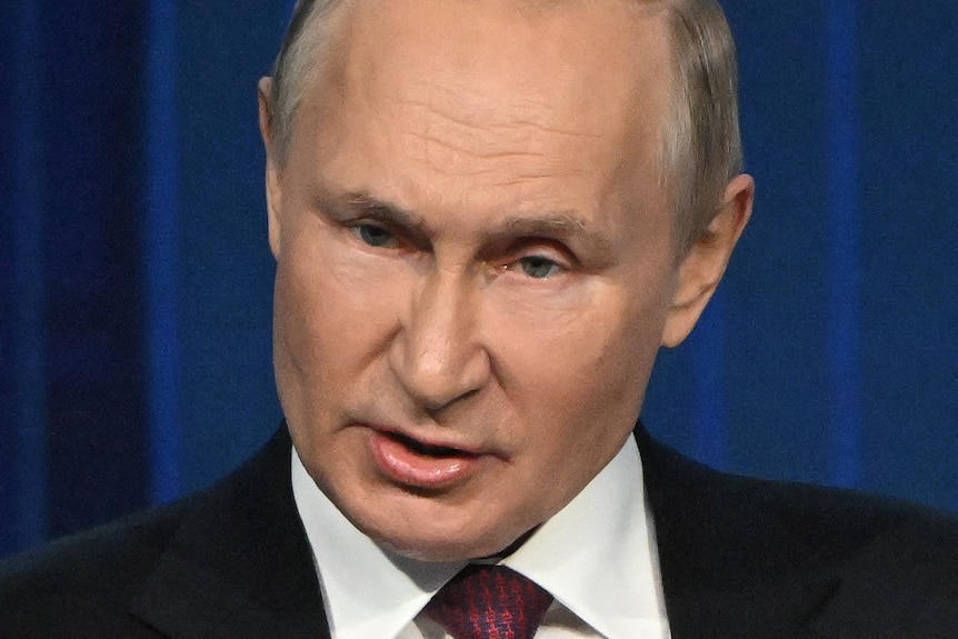 vladimir putin gestures during a speech