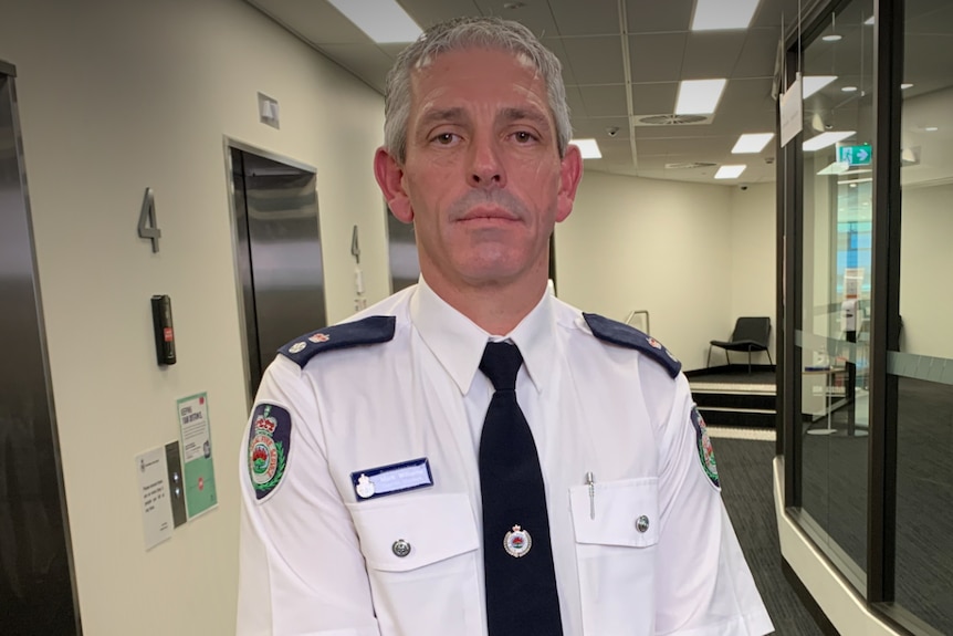 A man in uniform in an office.