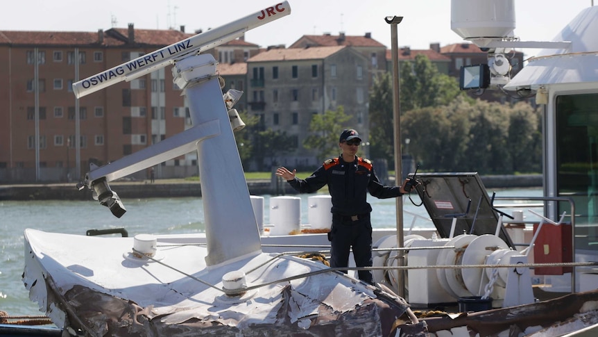 Italian Coast Guard officers inspect the tourist boat that was struck by a cruise line ship in Venice.