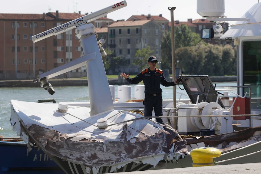 Italian Coast Guard officers inspect the tourist boat that was struck by a cruise line ship in Venice.