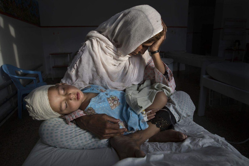 Najiba holds her two-year-old nephew Shabir who was injured from a bomb blast in Kabul