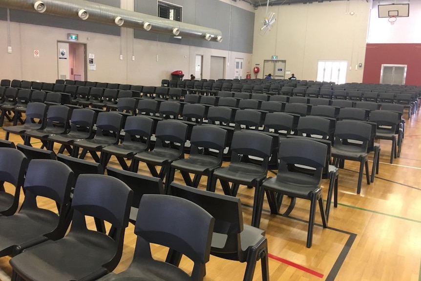 Chairs lined up at Townsville evacuation shelter ahead of Cyclone Debbie