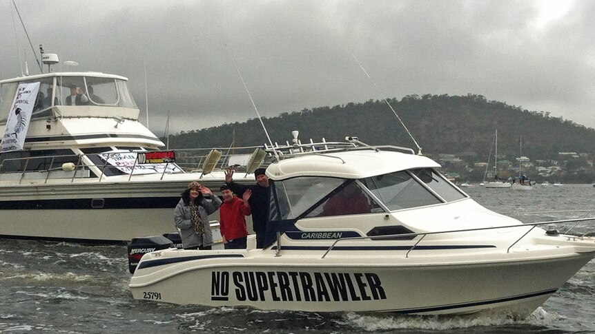 A boat travels down the River Derwent as part of a rally against a super trawler.