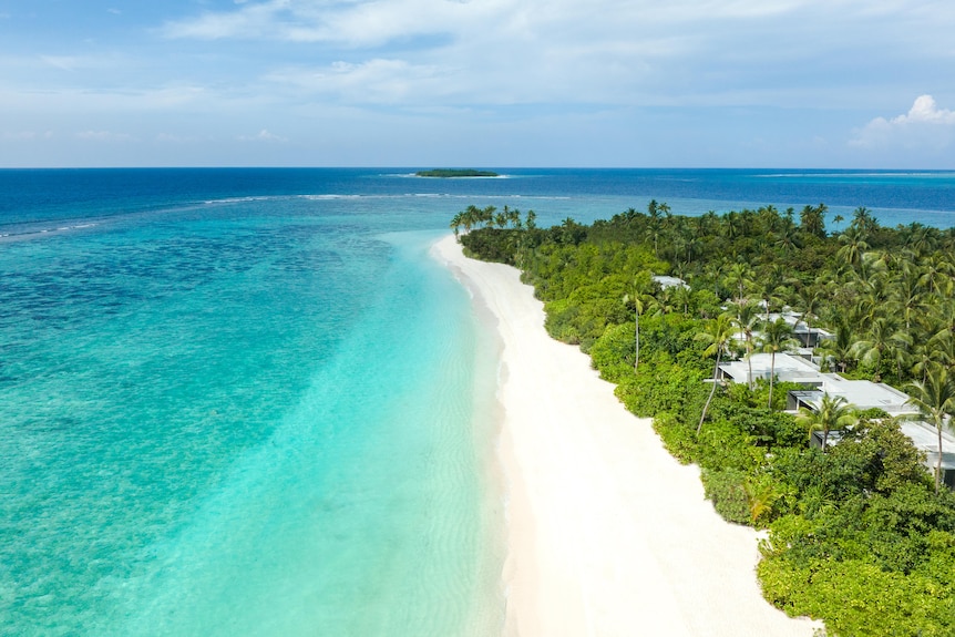 An aerial view of a white sand beach.