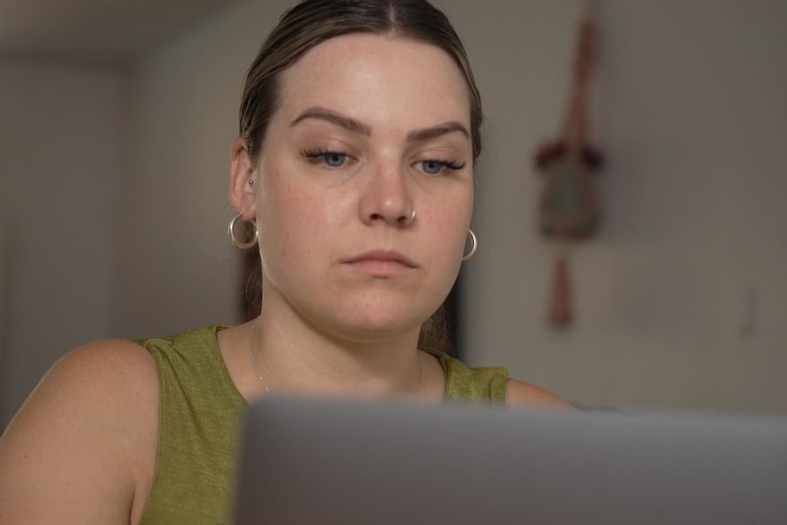 Green top woman sitting in her living room