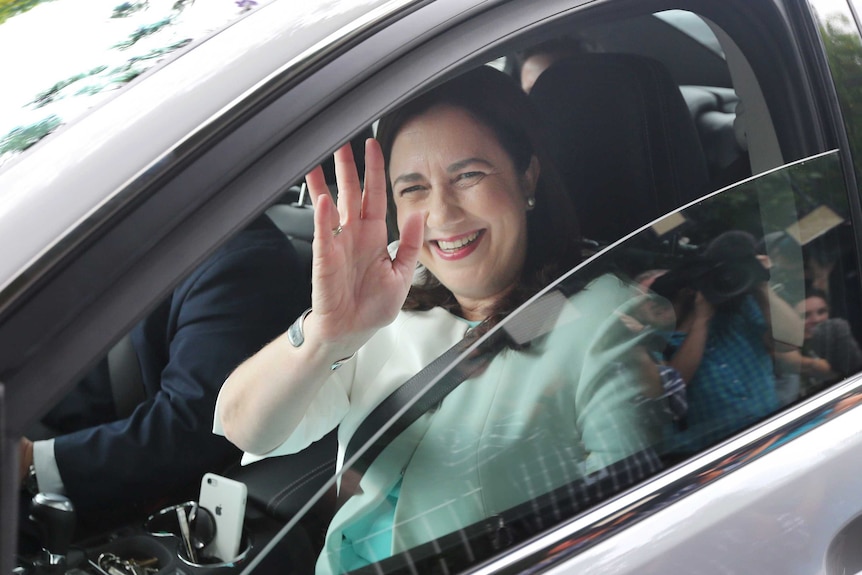 Queensland Premier Annastacia Palaszczuk waves as she arrives to Government House in Brisbane