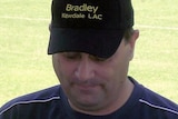 A headshot of Bradley Edwards on an oval wearing a black baseball cap with his name on it.