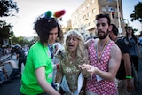 A participant of the Gay Pride parade in Jerusalem reacts a stabbing