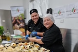 Two chefs smiling with food