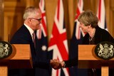 Malcolm Turnbull and Theresa May smile and shake hands during a news conference at Downing Street.