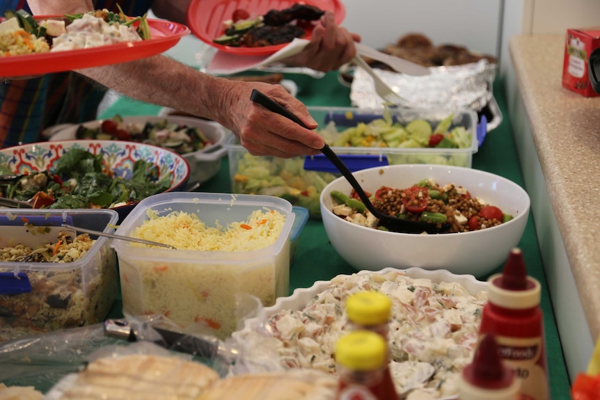 Bowls and containers filled with food spread out on a table