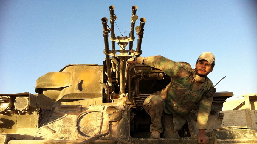 A Syrian army soldier exits his tank in the south-western neighborhood of the Syrian city of Qusayr.