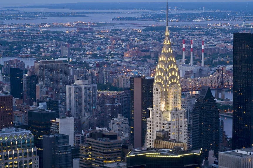 The Chrysler Building lit up at at night by its iconic lights