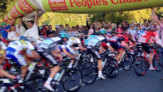 Ross Dobson (far right) was one of the spectators who helped hold up an inflatable arch, which fell onto the track at the Tour Down Under.