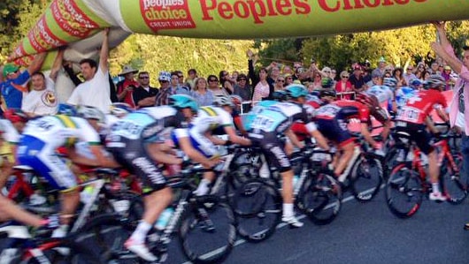 Ross Dobson (far right) was one of the spectators who helped hold up an inflatable arch, which fell onto the track at the Tour Down Under.