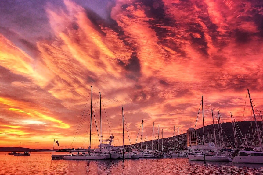 Sunset colours in sky over marina.