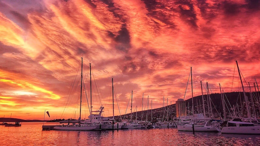 Sunset colours in sky over marina.