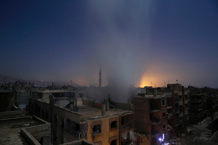 Smoke rises from a building following reported shelling by Syrian government forces in Syria.