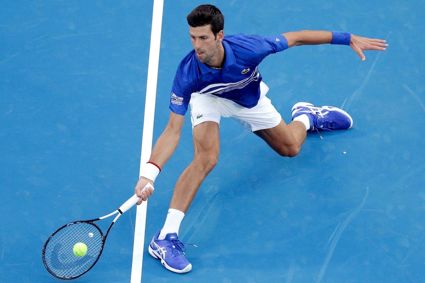 Novak Djokovic stretches for a forehand return against Mitchell Krueger.