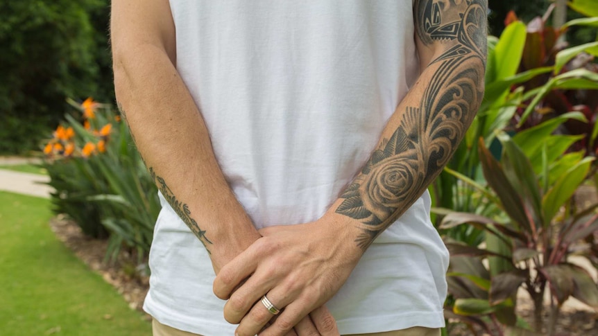 Kevin Gatti's tattooed arms.