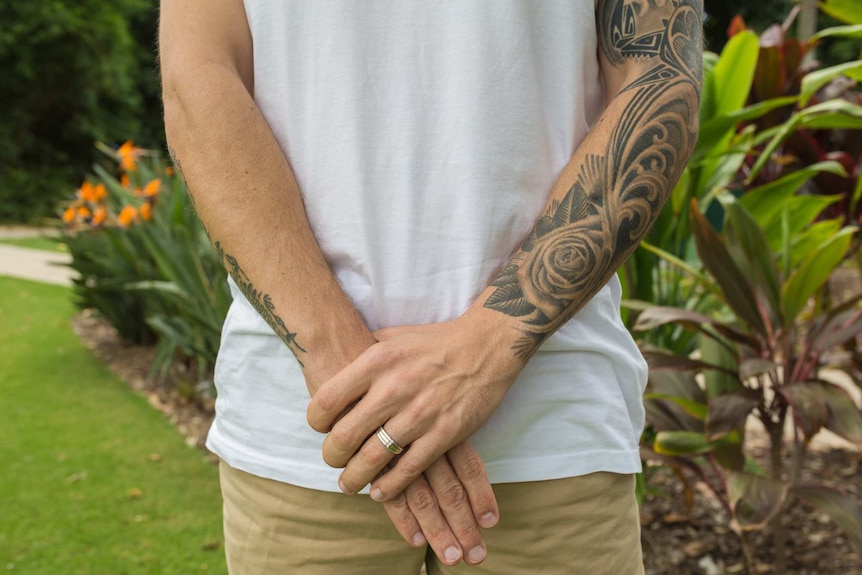 Kevin Gatti's tattooed arms.