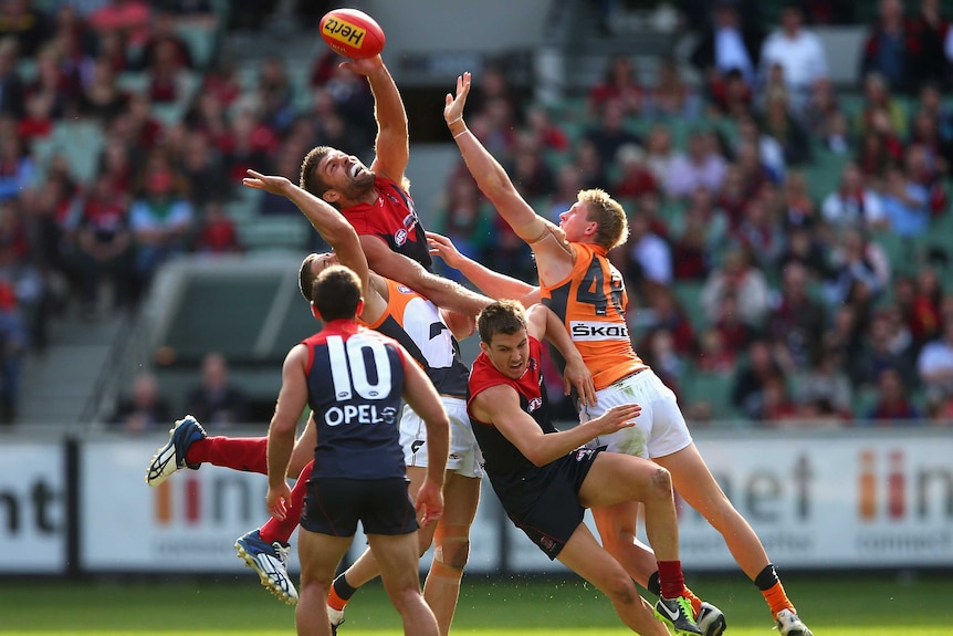 Mark Jamar taps the ball for Melbourne against Greater Western Sydney.