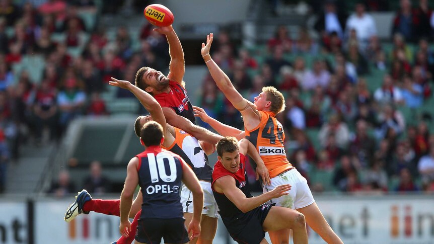 Mark Jamar taps the ball for Melbourne against Greater Western Sydney.