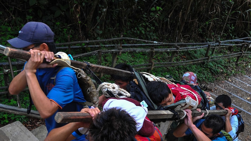 Guides carry injured off Mount Kinabalu