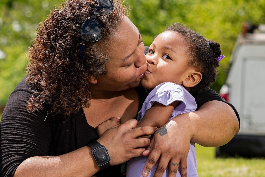 Tina Edwards kisses her daughter Ava.