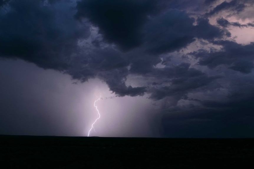 A lightning bolt hits the ground during a summer storm