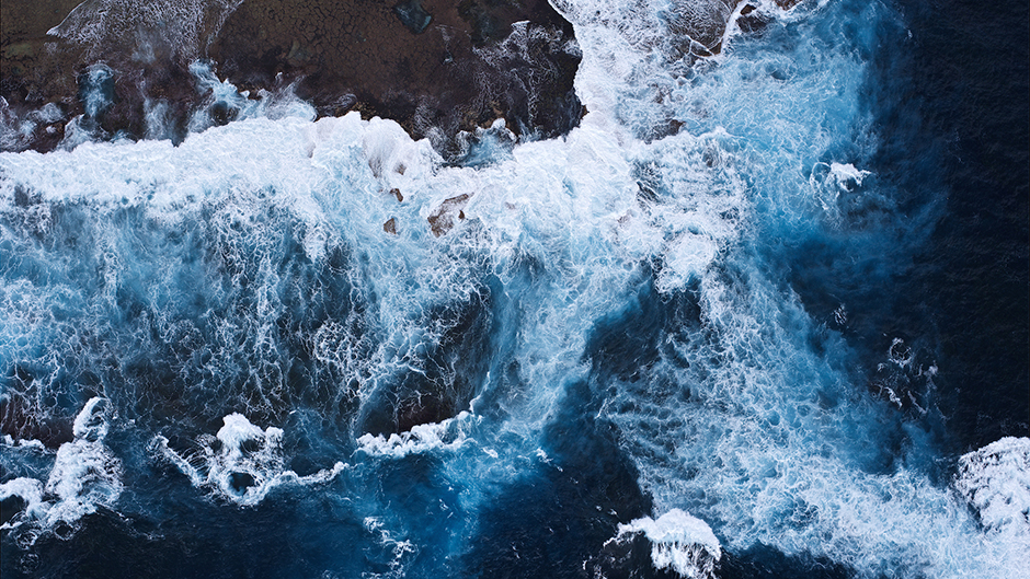An aerial photo of waves crashing onto Rottnest Island.