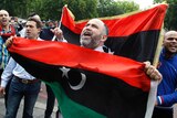 Libyan rebel supporters gather outside the Libyan embassy in London.