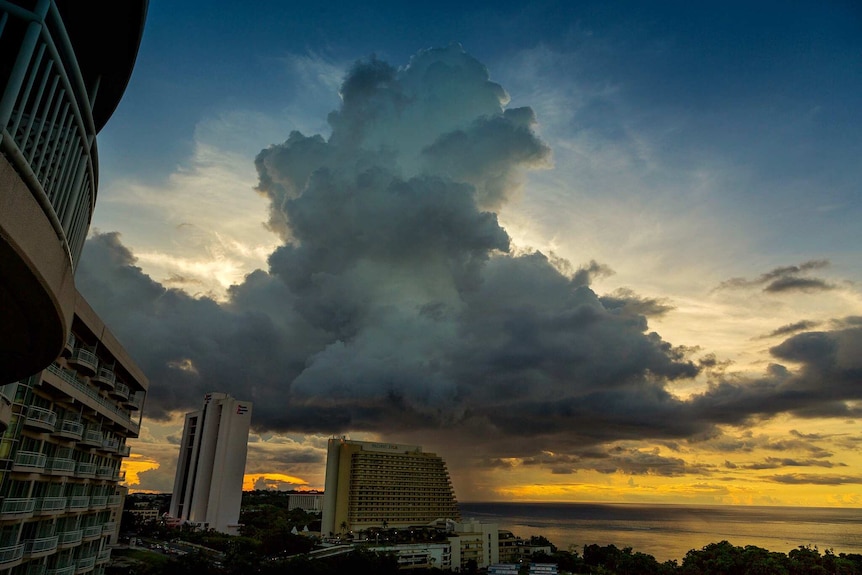 Huge storm clouds over Guam beach at sunset.