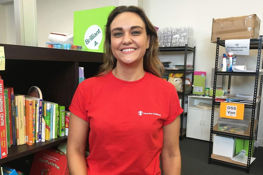 Kate Heron, a Gold Coast domestic violence mobile outreach worker, stands in an office in Brisbane.