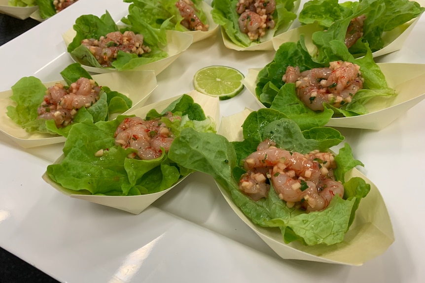 Arranged in paper boats lined with lettuce leaves, these prawn ceviches have a glossy, appetising salsa over them