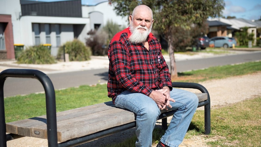 Robert Muir sitting on a wooden bench