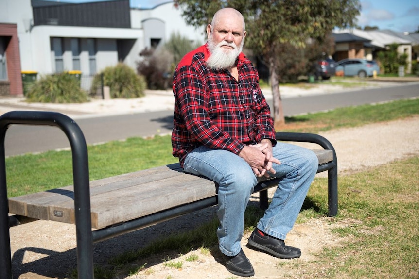 Robert Muir sitting on a wooden bench