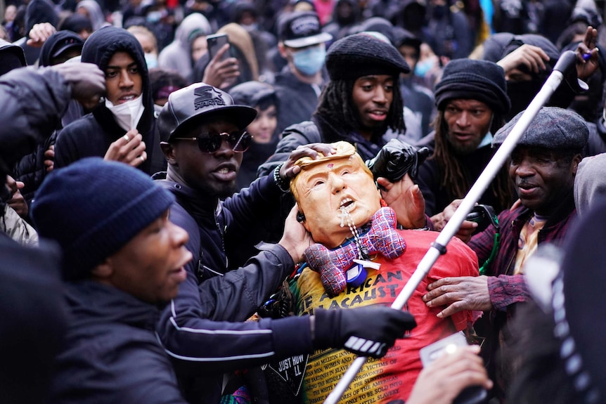 Demonstrators attack a dummy depicting US President Donald Trump.