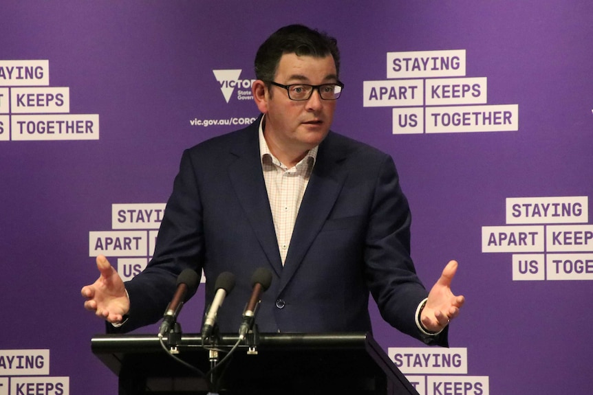 Victorian Premier Daniel Andrews at a press conference on Friday, September 11, speaking at a podium with a purple backgound.